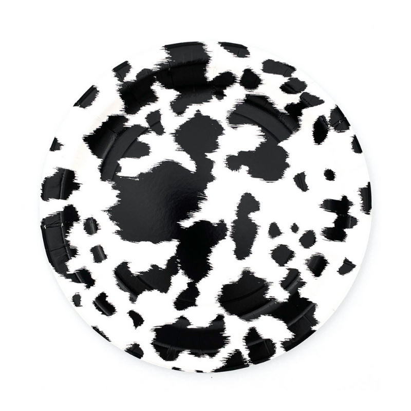 Cowhide print black and white paper dinner plate on white background.