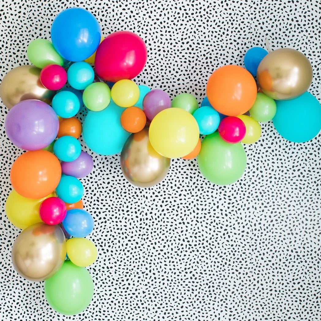 Party animal balloon arch garland with the colors chrome gold, orange, caribbean blue, yellow, periwinkle, lime, spring lilac and either red or wildberry.