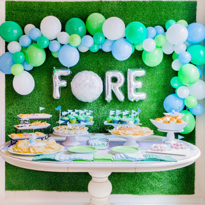 Golf balloon garland in white, lime, spring green, and light blue colors used for golf party decor.