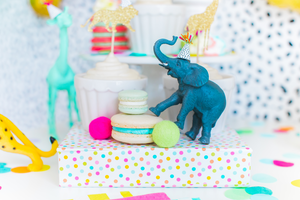 Safari animals wearing mini party hats with multi-color fringe and a mix of pom-pom colors in a party animal theme.