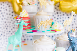 Safari animals wearing mini party hats with multi-color fringe and a mix of pom-pom colors in a party animal theme.