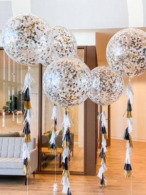 Five 3ft clear balloon stuffed with tissue confetti and tissue tassel string in the colors white, black, and gold.