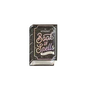 A black book of spells shaped plate with holographic foil accents sits on a white background.