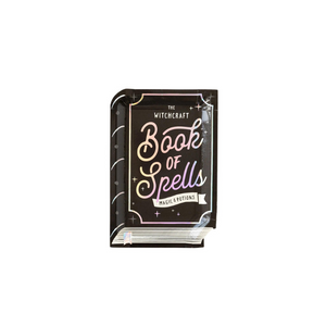 A black book of spells shaped plate with holographic foil accents sits on a white background.