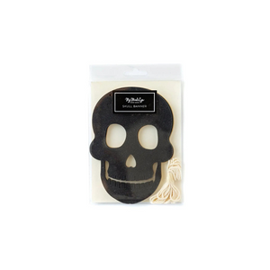 A gold and black skull banner inside clear packaging found at Glamfetti.com.