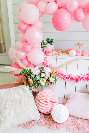 A close up view shows the garland and other pretty decorations made from florals and tissue.