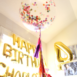 Jumbo 3ft clear balloon stuffed with multicolor tissue confetti with matching tassel balloon string.