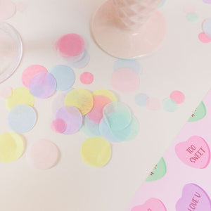 Pile of pastel colored hand cut tissue confetti paper on a table.