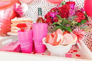 A pink and red set up for a Galentines party celebration.