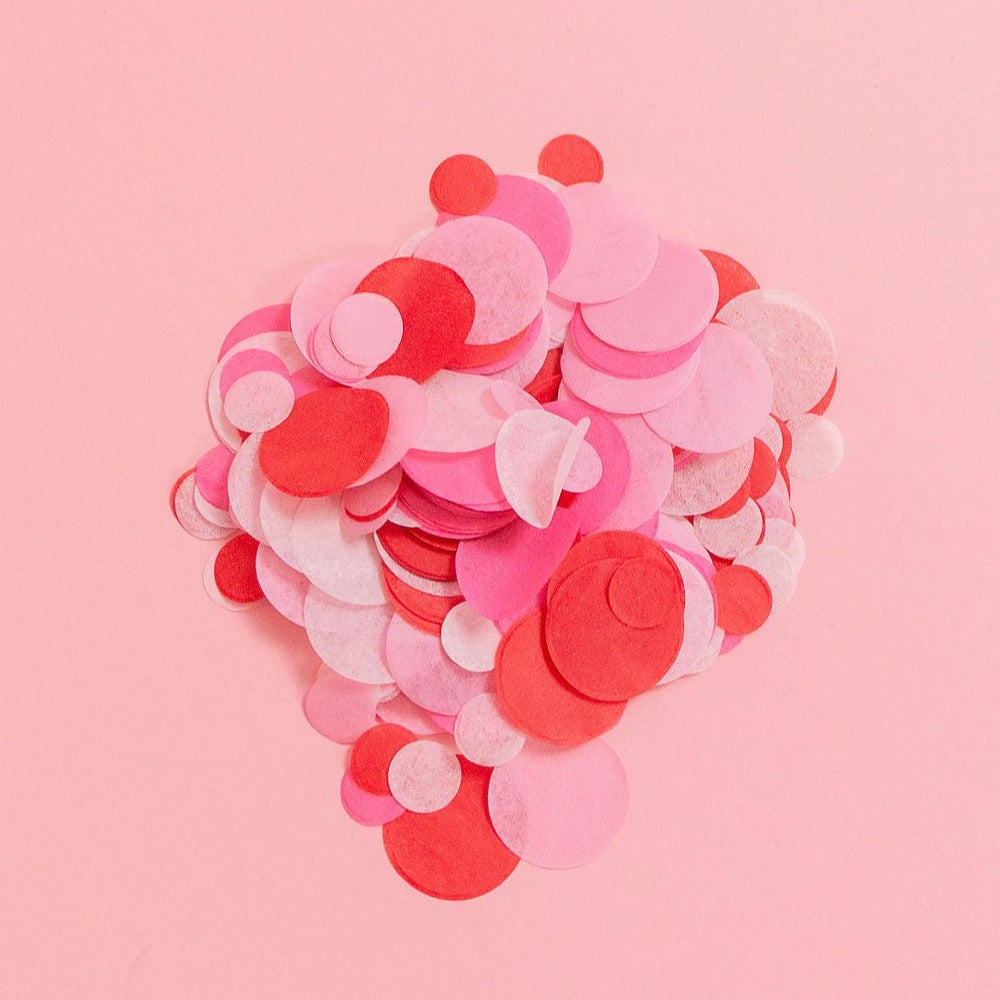 A pile of Hot Pink, Red, Pink, Blush Tissue Confetti on a pink background.
