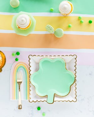 Pastel rainbow napkins with pastel green clover plates.
