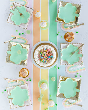 Pastel rainbow napkins with pastel green clover plates.