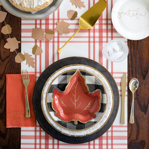 A beautiful thanksgiving tablescape with black, orange, and gold accents. 