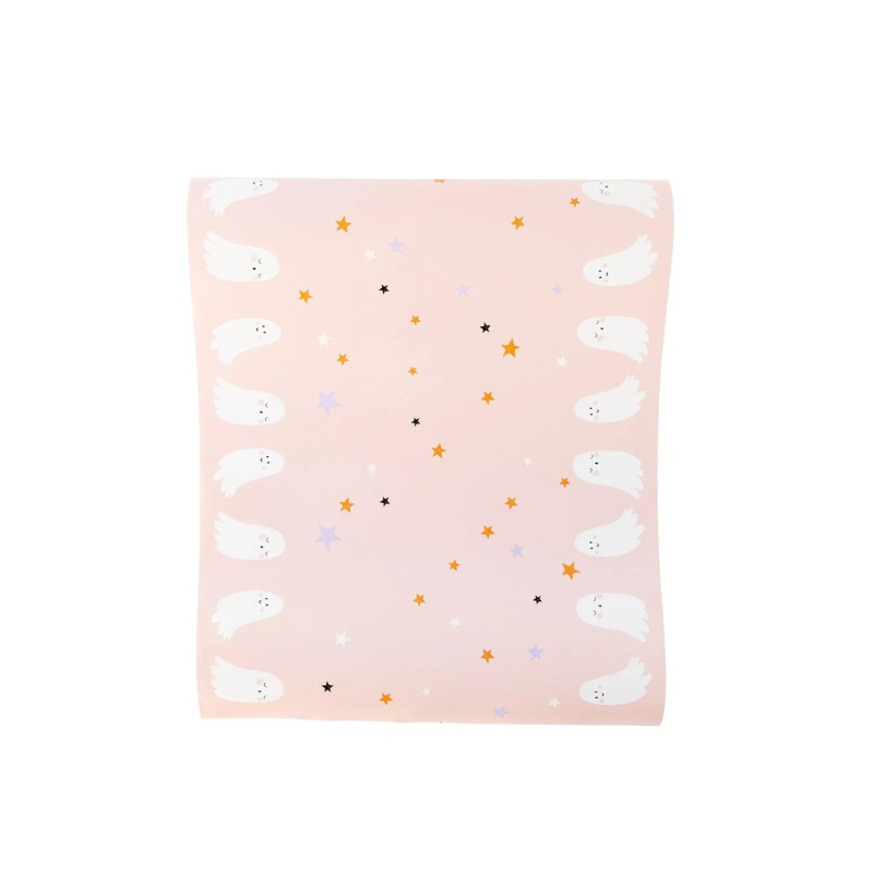 A photo of a cute pink table runner with white ghosts and orange, black, white, and gray stars.