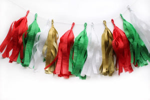 A tissue tassel garland in a color assortment of red, green, white, and gold.