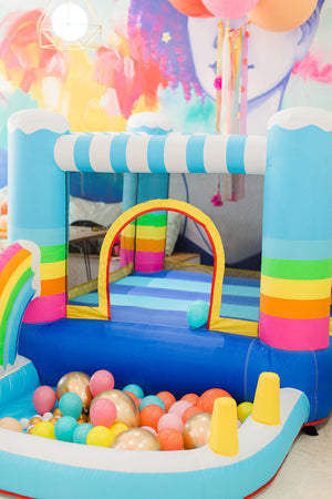 Kids bouncing play pit with multi color chrome balloons.