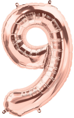 A rose gold colored number nine balloon inflated to show detail.