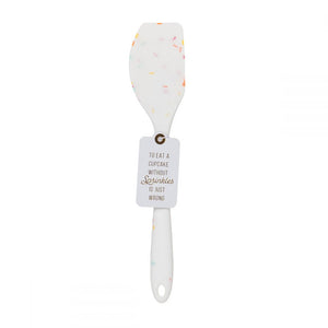 A silicone white confetti spatulas with cute saying TO EAT A CUPCAKE WITHOUT SPRINKLES IS JUST WRONG.