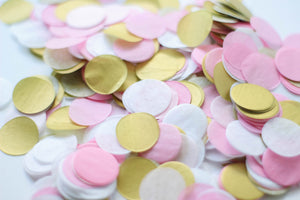 Close up of 1 inch handcut confetti circles in the colors pink, blush, white, and gold used in party celebrations, bachelorette, princess party, or girls birthday.