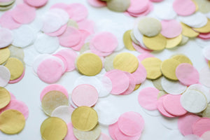 Close up of a pile of 1 inch handcut confetti circles in the colors pink, blush, white, and gold used in party celebrations, bachelorette, princess party, or girls birthday.
