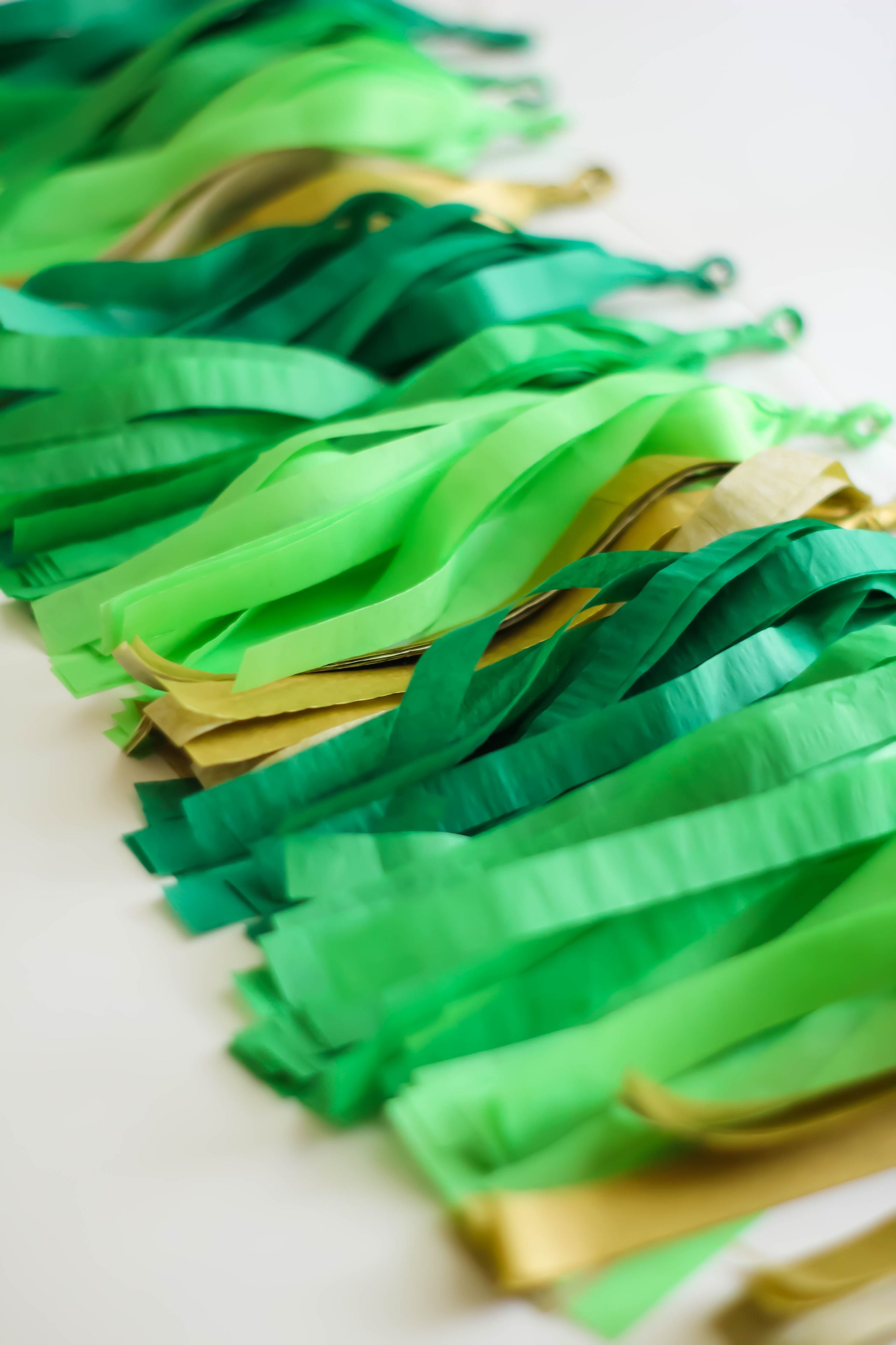 Hand made and hand rolled tissue garland in the colors emerald, green, lime, and gold perfect for any occasion or St. Patricks Day!