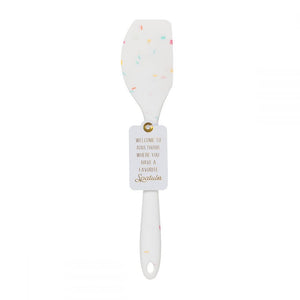 A silicone white confetti spatulas with a cute saying WELCOME TO ADULTHOOD, WHERE YOU HAVE A FAVORITE SPATULA.